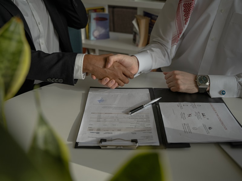 Handshake over a signed agreement on a clipboard